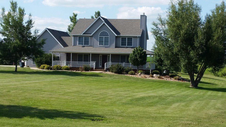 A large house with a large lawn in front of it