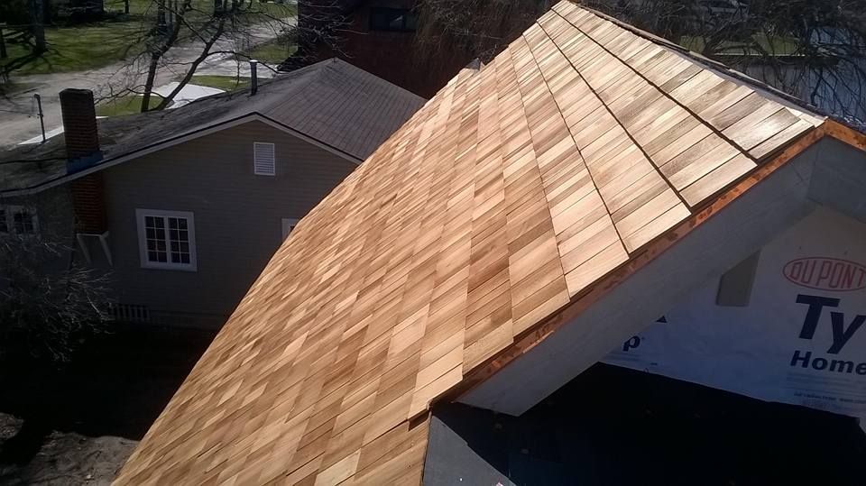 A wooden roof is being installed on a house