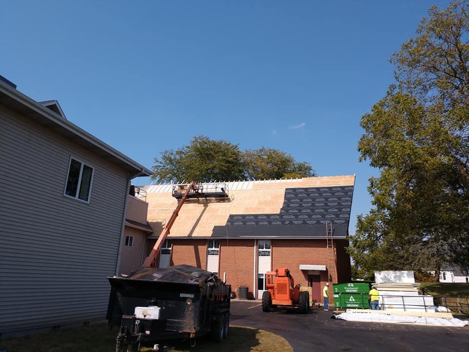 A roof is being installed on a brick house