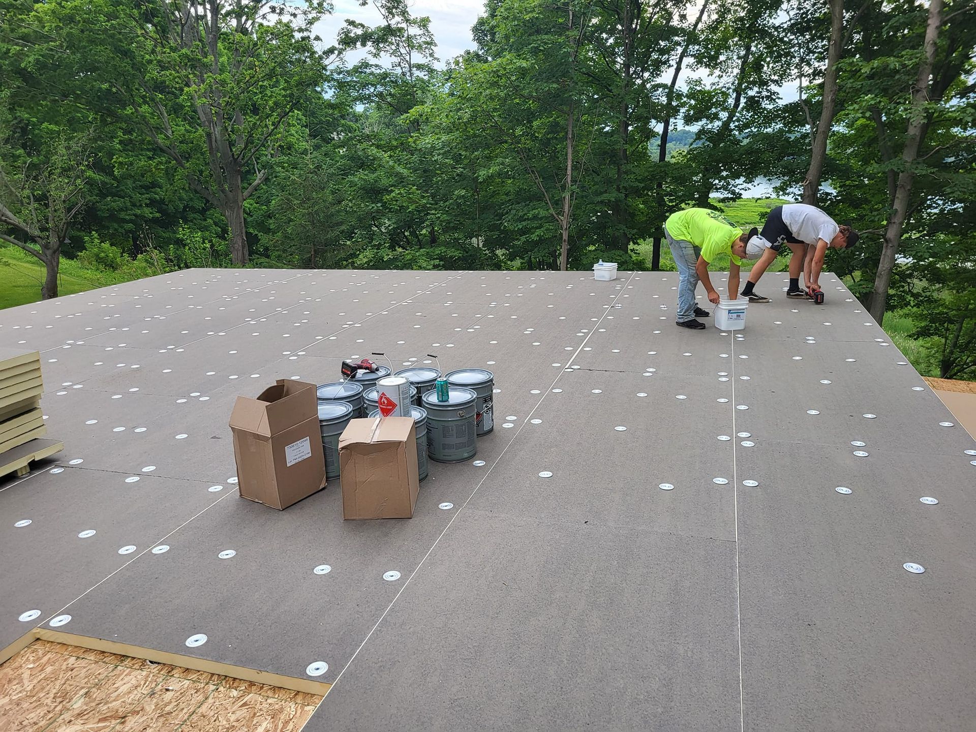 A group of men are working on a roof.