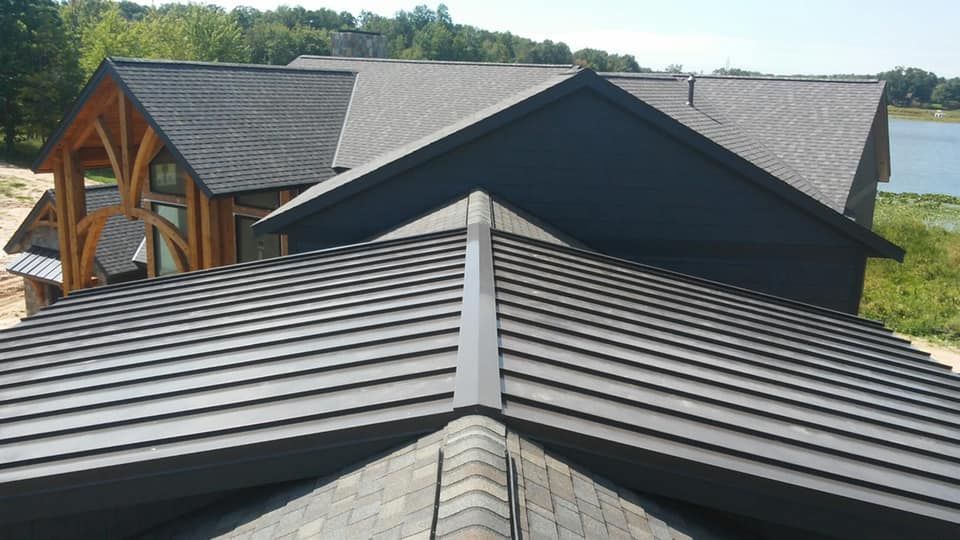 The roof of a house with a lake in the background.