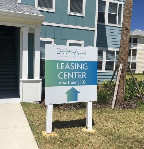 A sign that says domain leasing center apartment 101