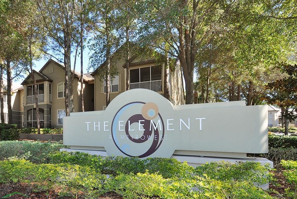 A sign for the element is in front of a building