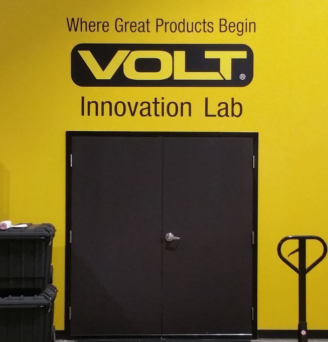 A yellow wall with the words volt innovation lab on it