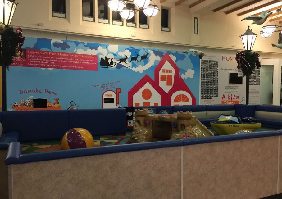 A room with a mural on the wall that says santa claus