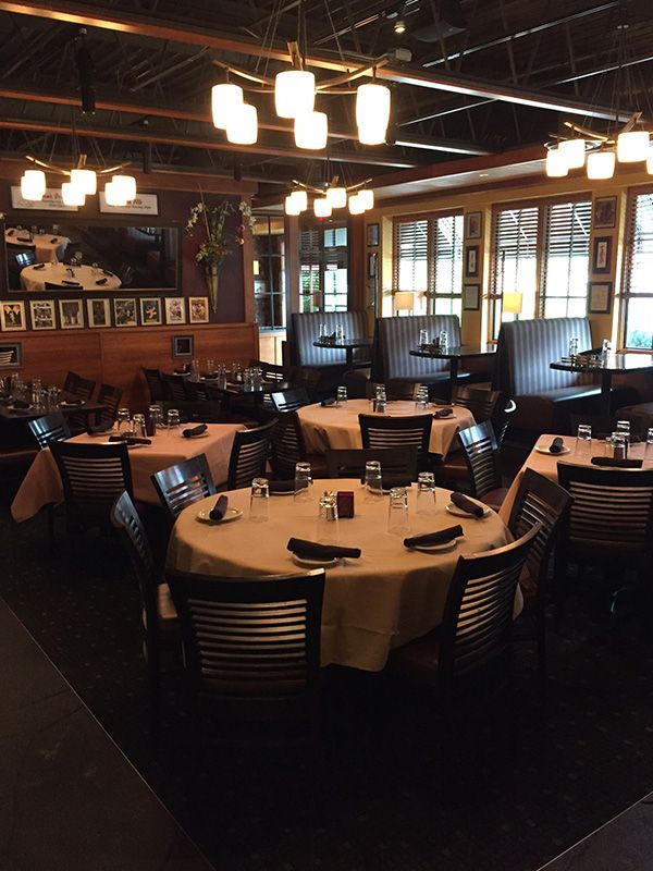 Interior of a restaurant with round tables set for dining