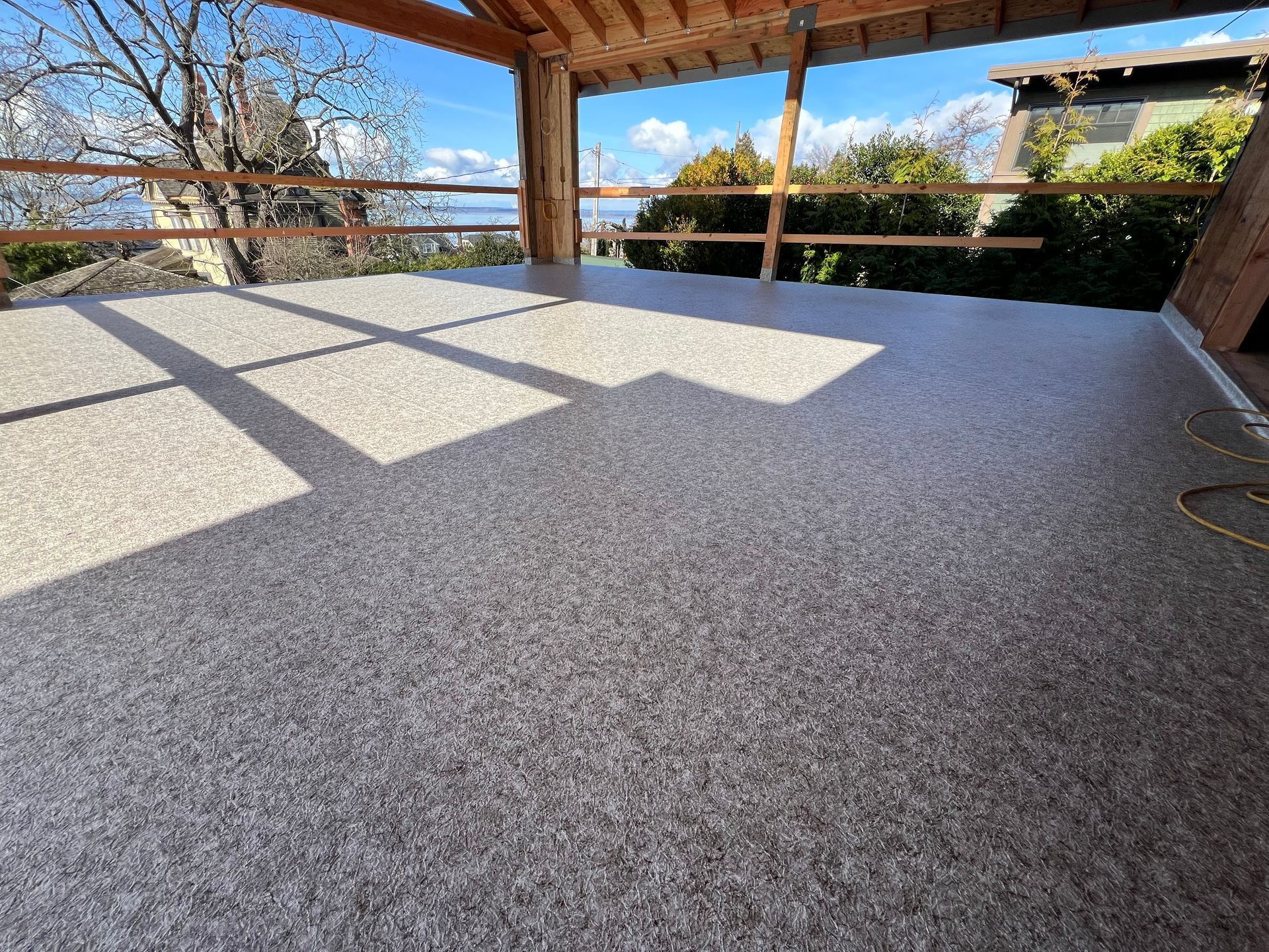 A balcony with a view of a city and trees.