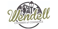 Logo for the Wendell Chamber of Commerce featuring stylized text over a circular icon of buildings and a street lamp.
