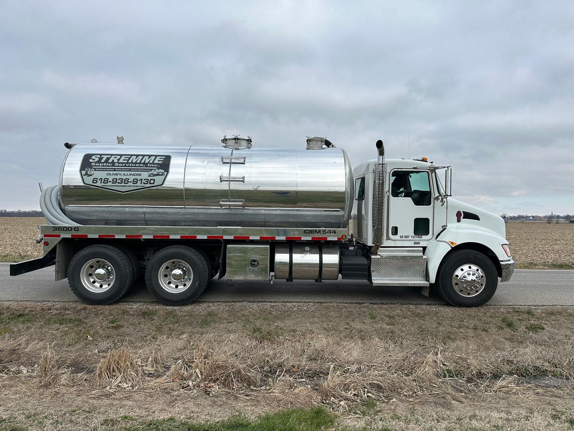 a streamme septic truck is parked on a gravel road