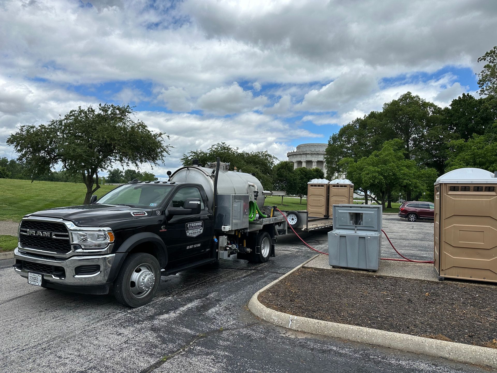 A truck with a trailer attached to it is parked in a parking lot.