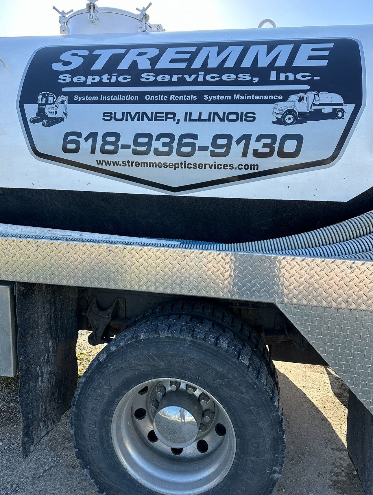 A Stremme Septic Services truck is parked on the side of the road