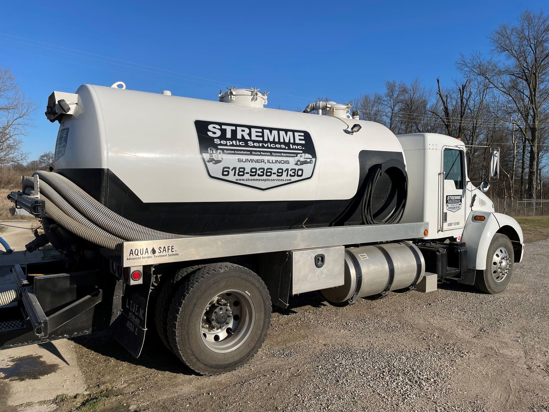 a streamme septic truck is parked on a gravel road
