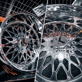 Chrome car rims with intricate geometric design and center cap.