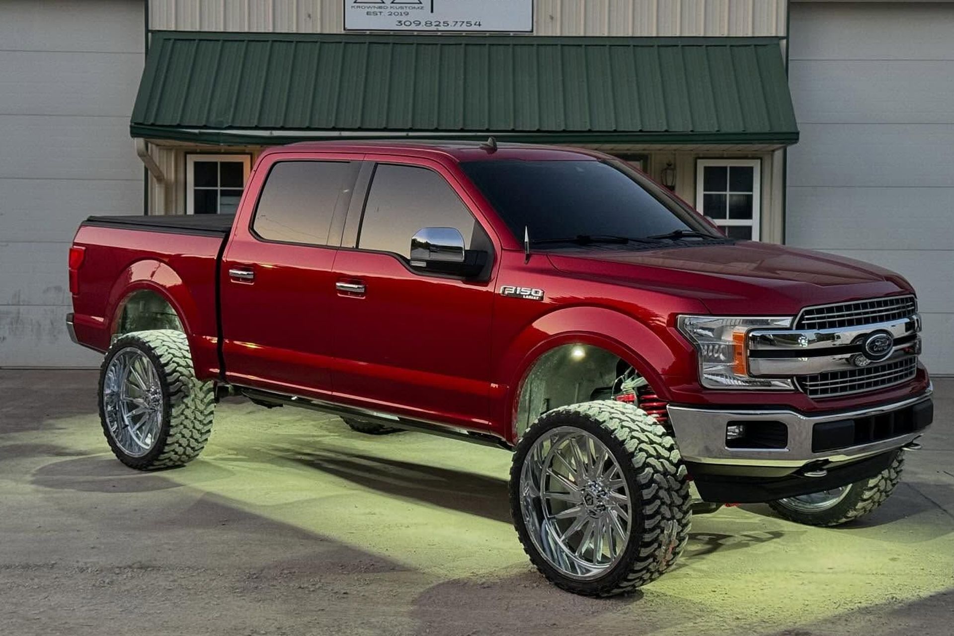 White Ford Bronco with black wheels on a snowy ground.