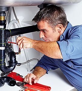 Plumber repairing the sink pipes