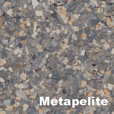 Textured flooring sample, Metapelite color. Granite-like, with gray, tan, and white irregular shapes.