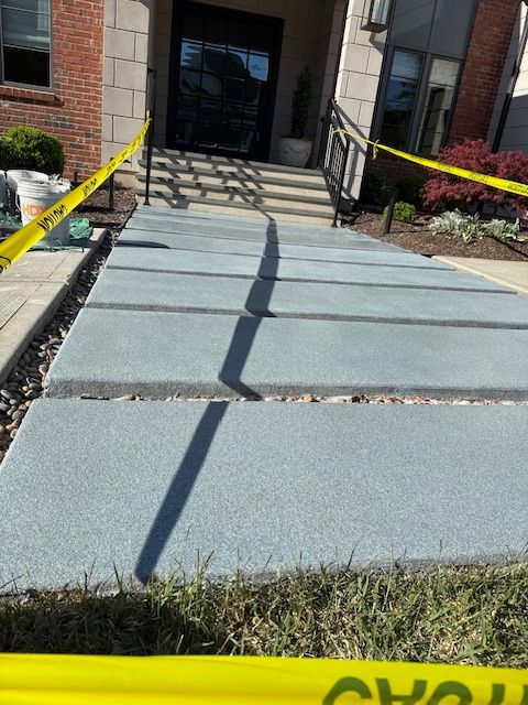 A concrete walkway is surrounded by yellow caution tape