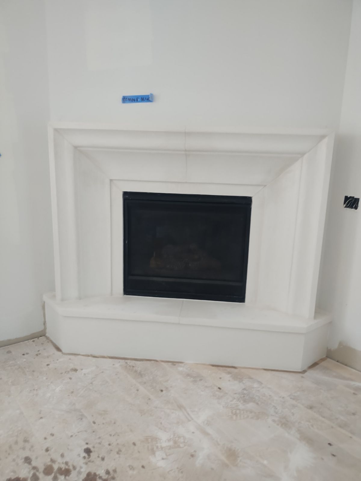There is a fireplace in the corner of the room.