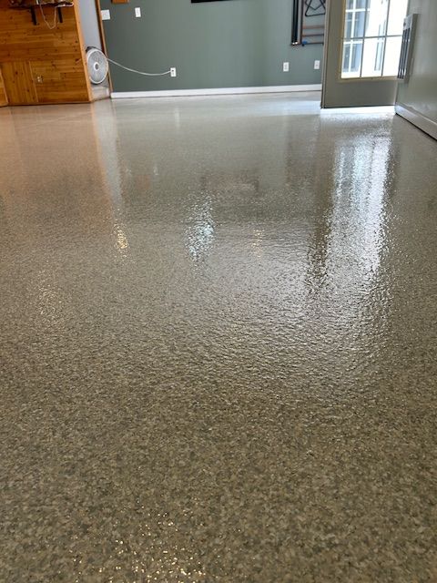 A living room with a shiny floor and a sliding glass door.
