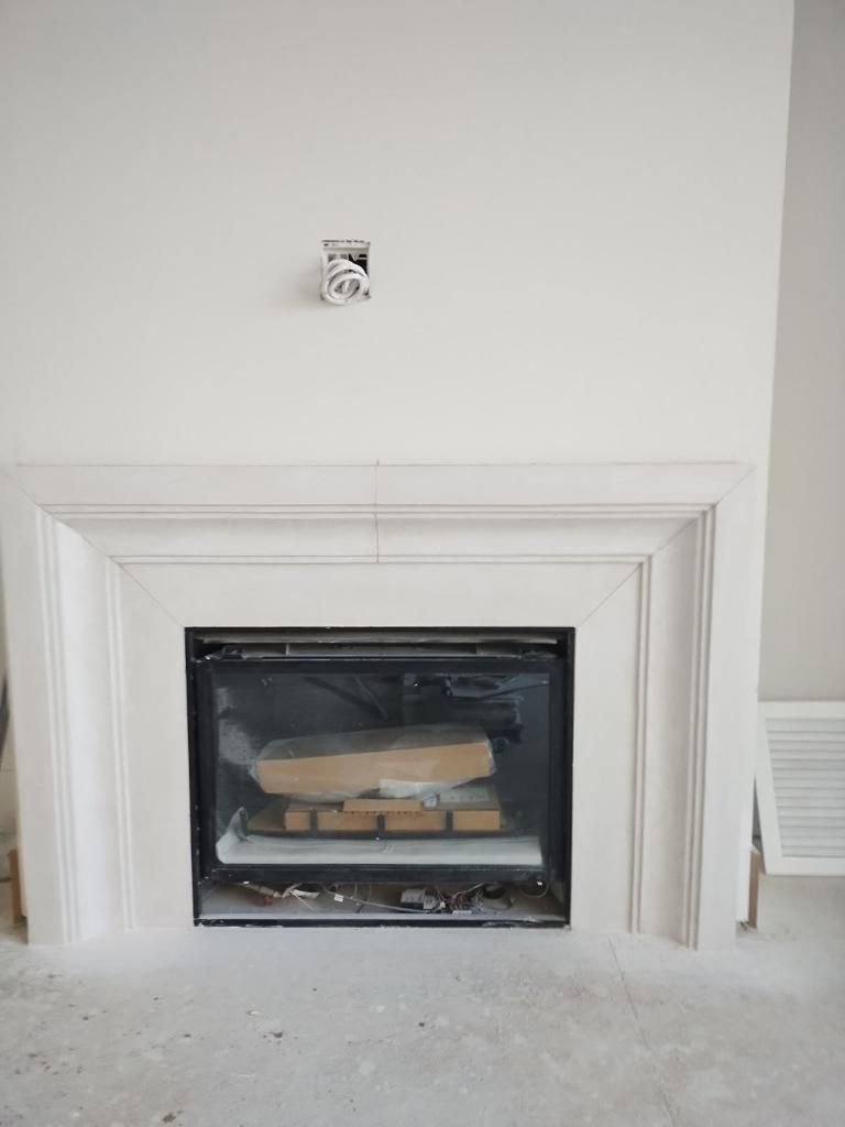 A fireplace with a stack of logs in it