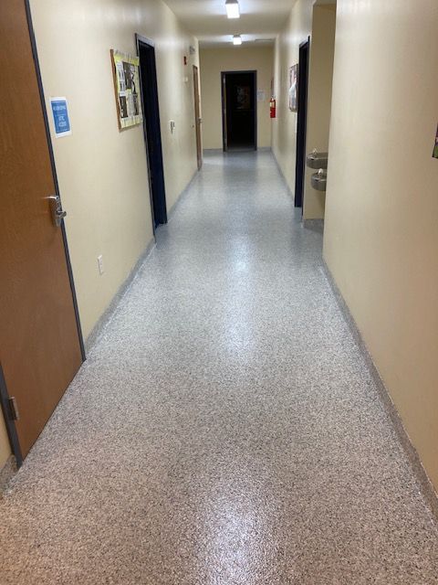 A long hallway with a water fountain in the middle of it.