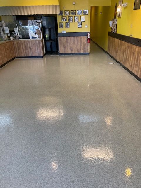 An empty restaurant with a white floor and yellow walls