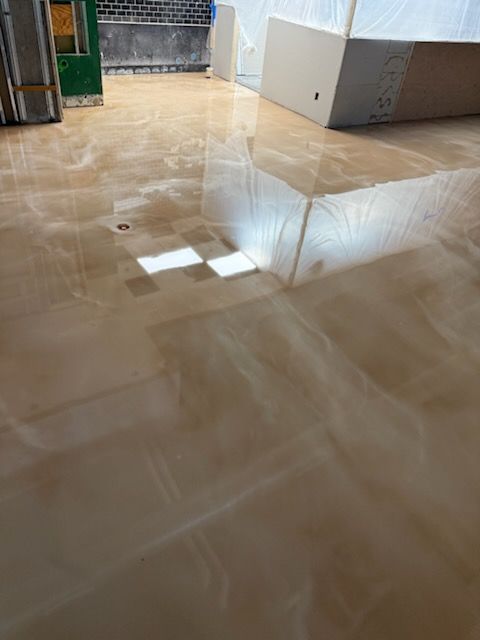 A tiled floor with a reflection of a window in it