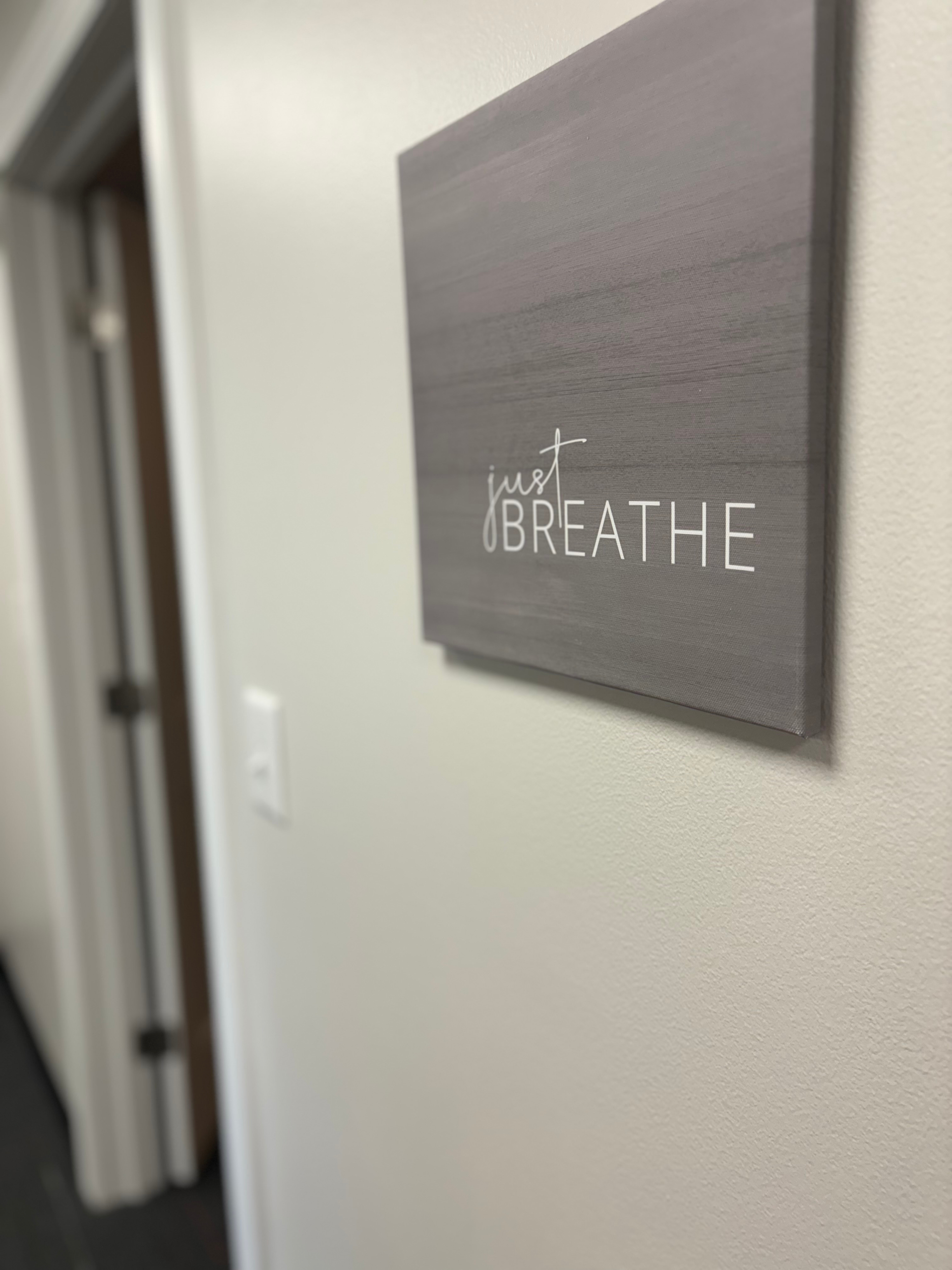 Gray sign on wall reads 