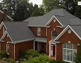 Red brick house with a gray roof and white trim.