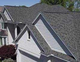House with a gray asphalt shingle roof and white siding.