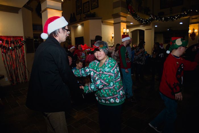 A group of people are dancing at a christmas party.