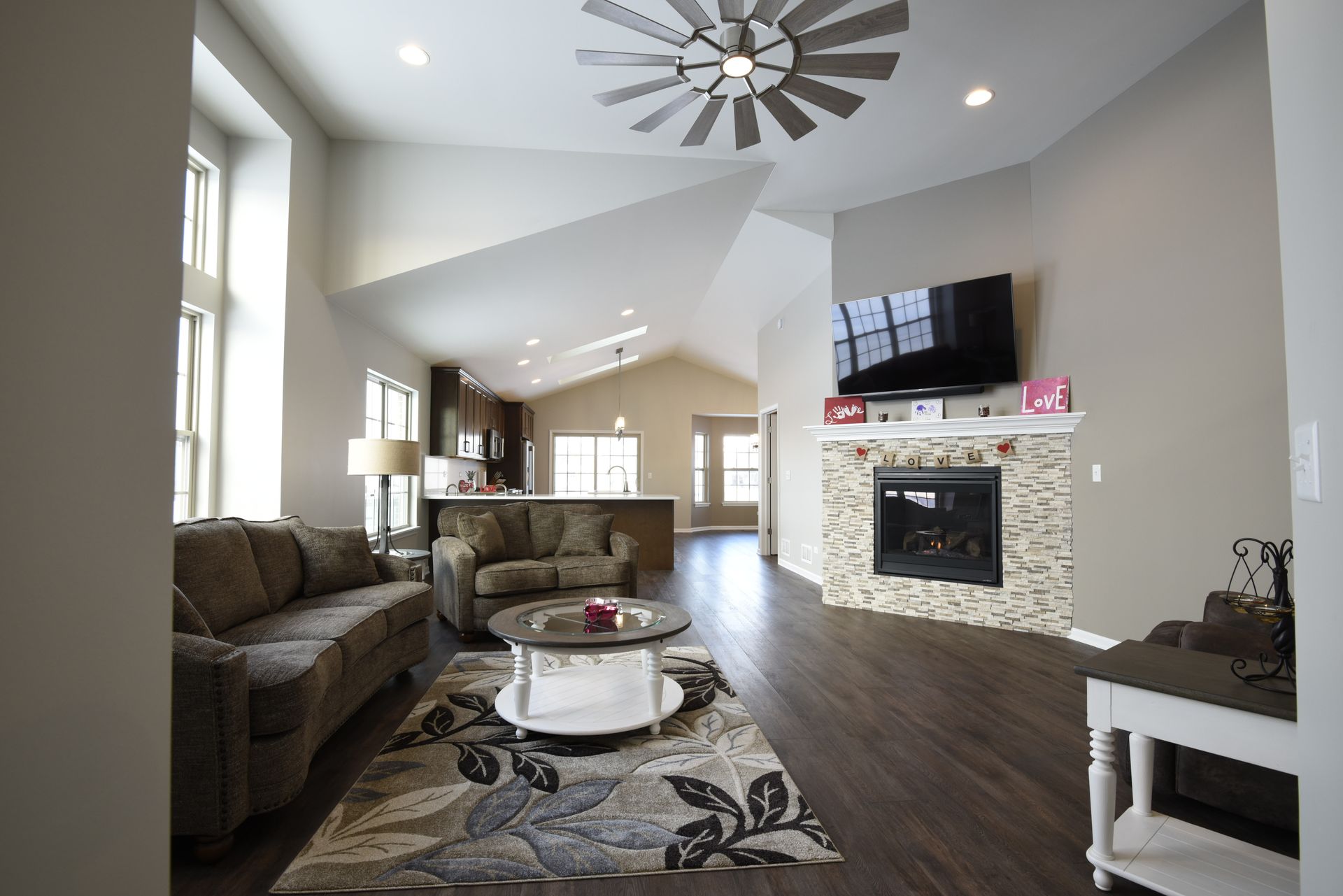 A living room with a ceiling fan and a fireplace