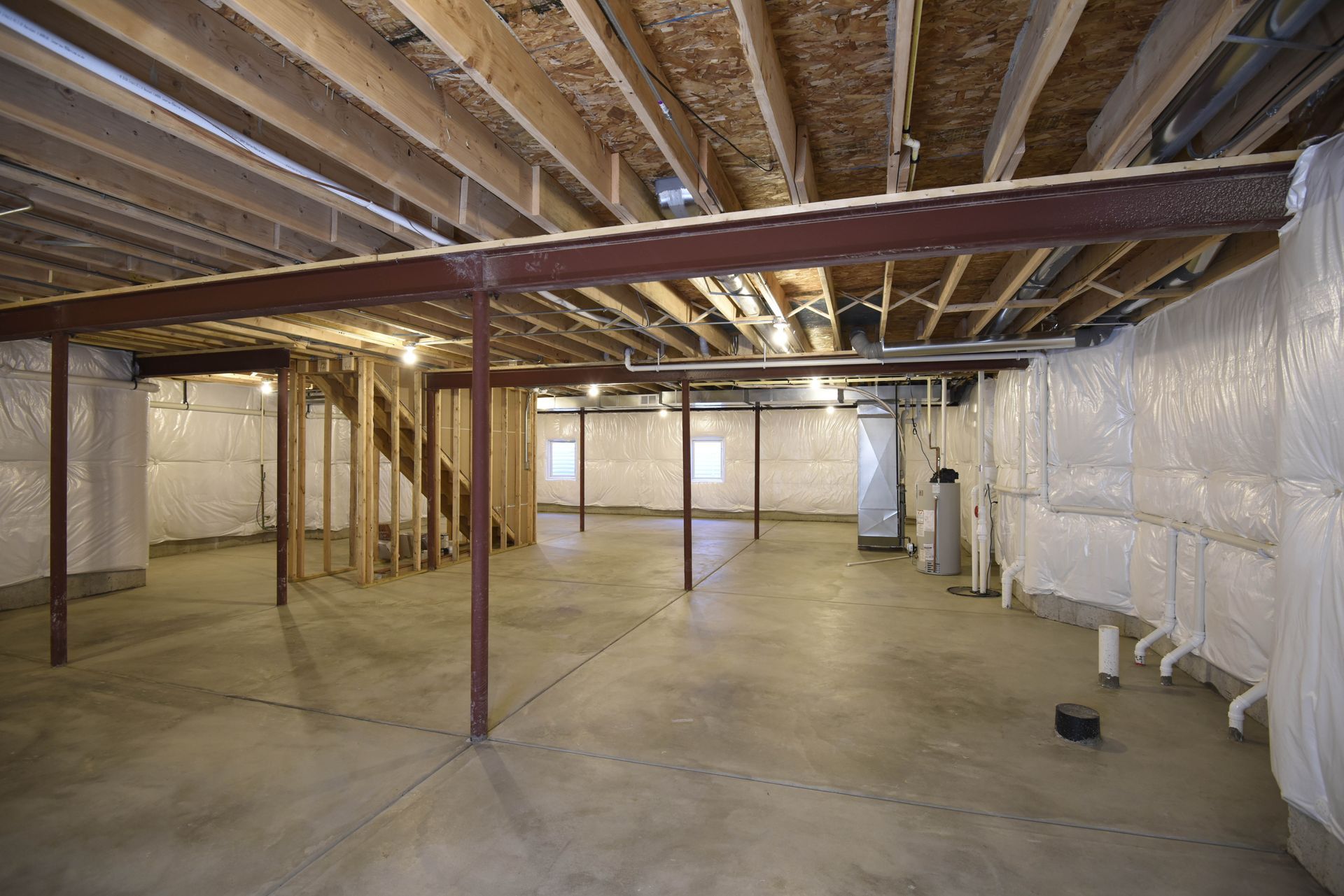 A laundry room with a sink, refrigerator, washer and dryer.