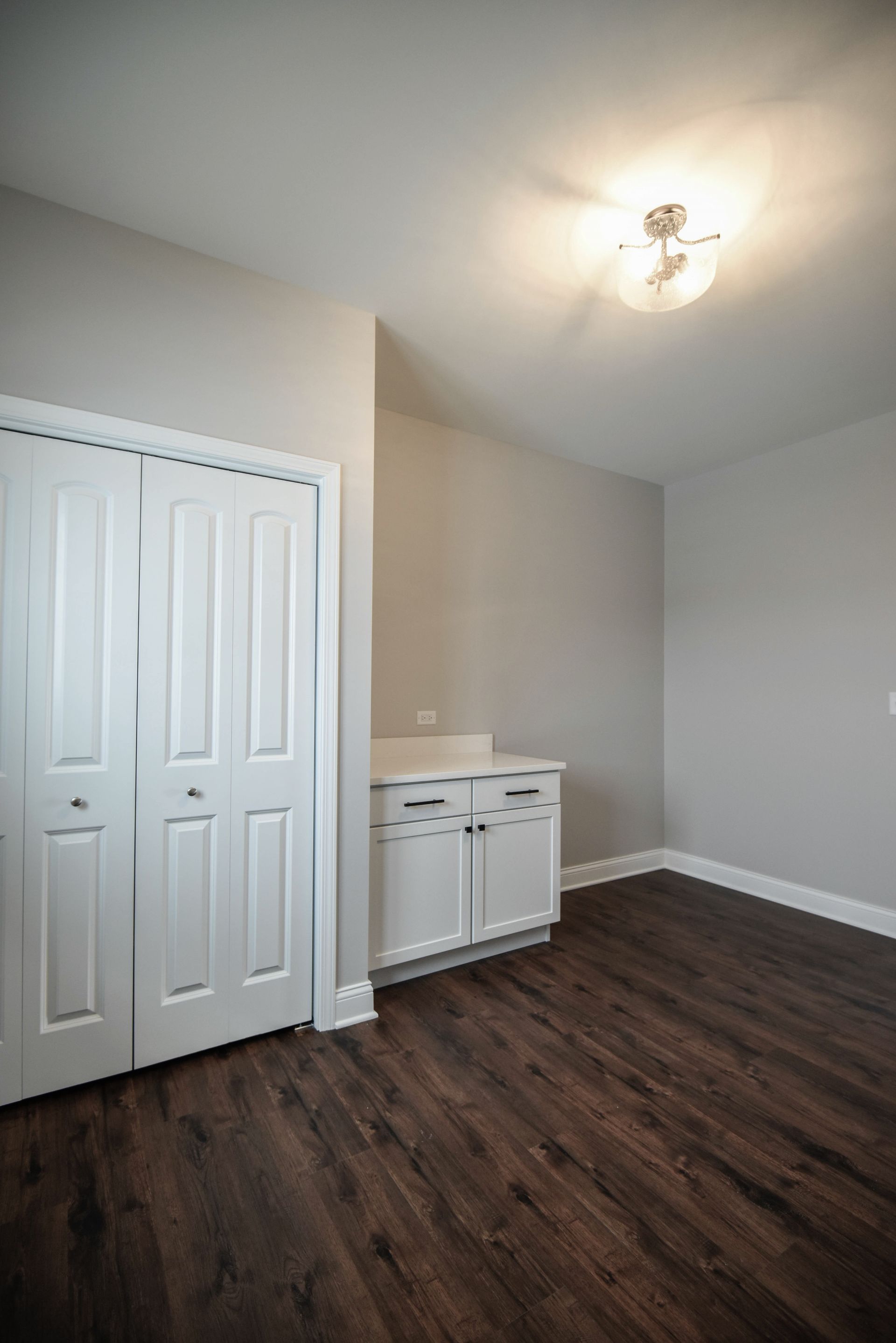 A bathroom shower with a tiled wall and a niche in the corner.