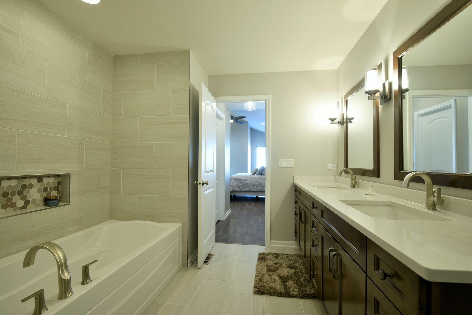 A bathroom with two sinks, a tub, and a walk in shower.