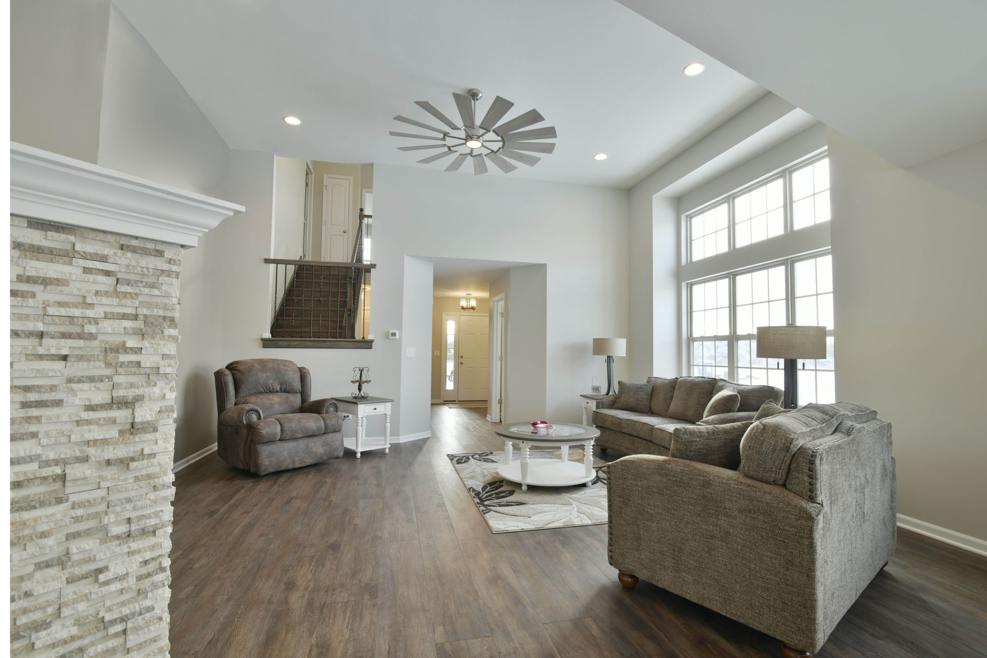 An empty bedroom with a ceiling fan and two closets.
