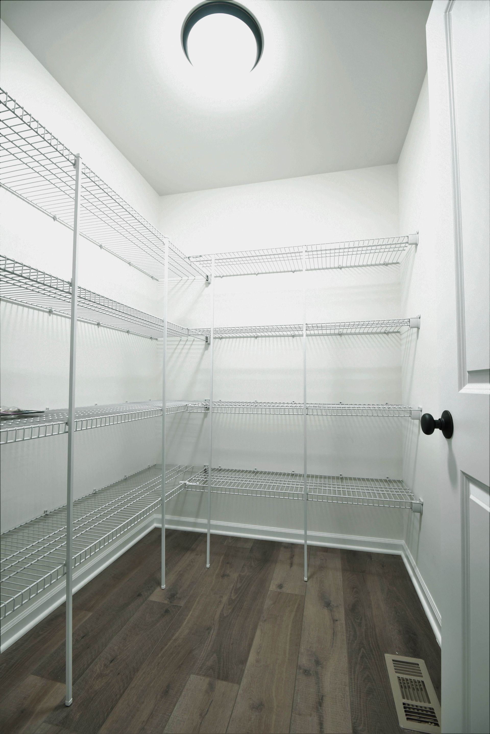A hallway leading to a staircase in a house.