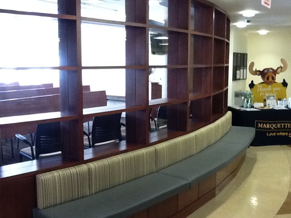 A laundry room with wooden cabinets and a sink