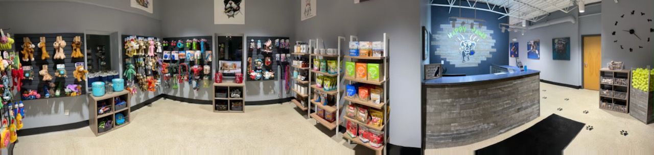 A panoramic view of a store filled with lots of shelves and a counter