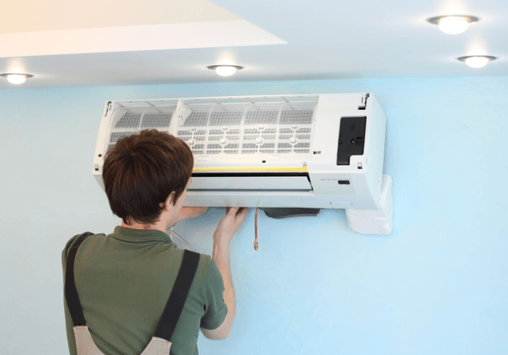 technician installing split type air conditioner