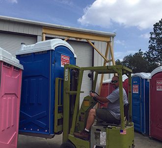 Jamie loading a portable toilet