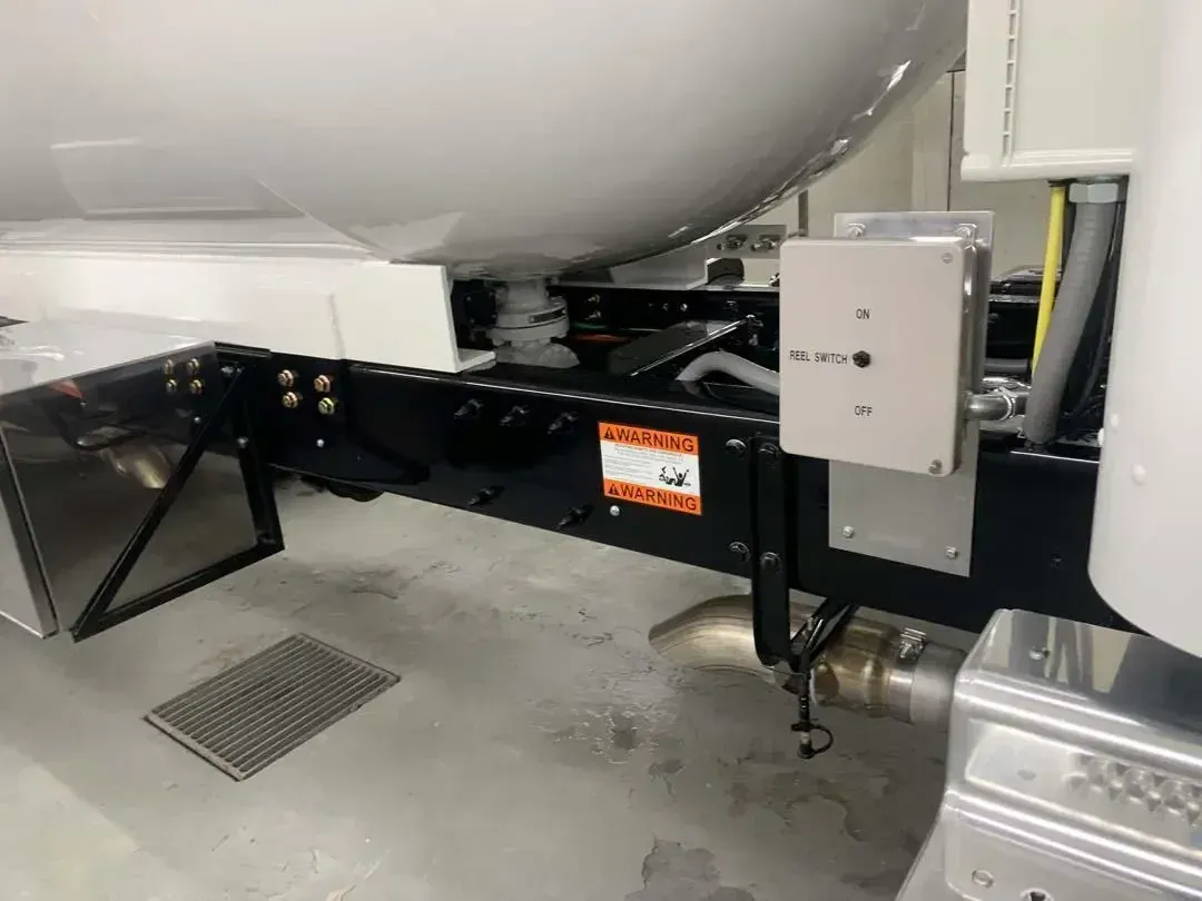 A white truck is parked on a concrete floor.