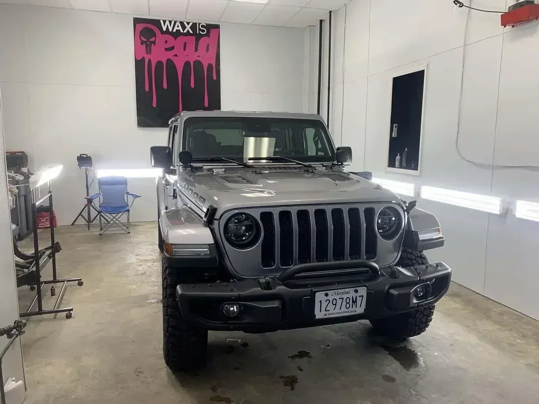 A jeep is parked in a garage.