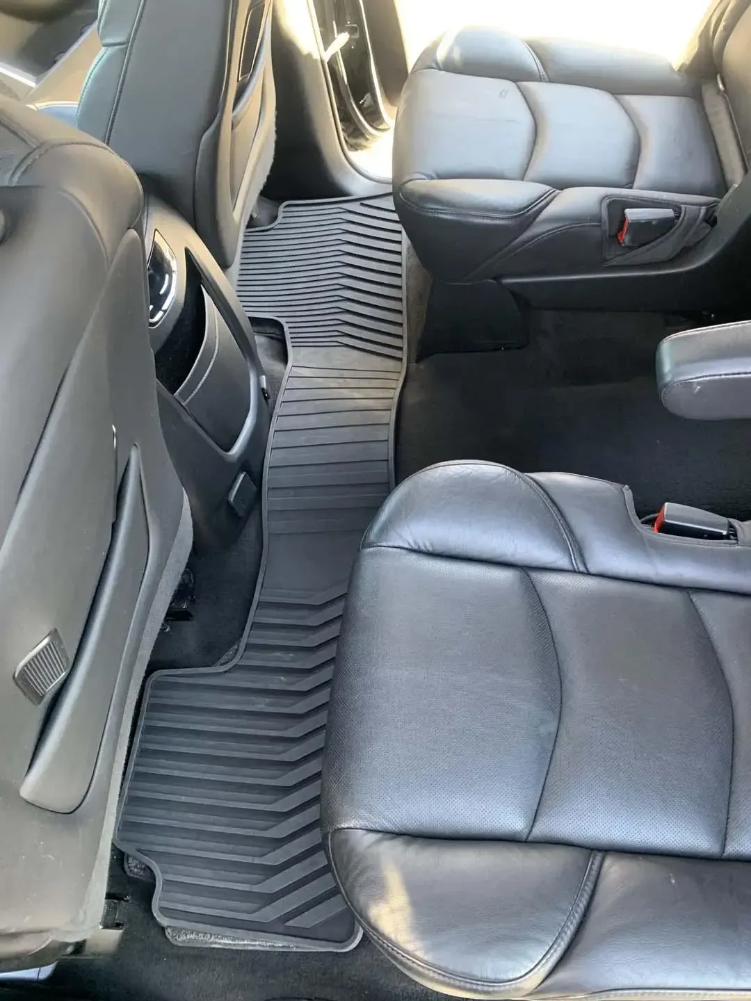 The interior of a car with leather seats and floor mats.
