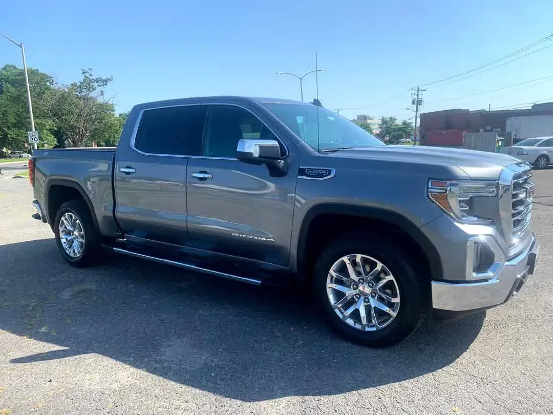 A gray pickup truck is parked in a parking lot.