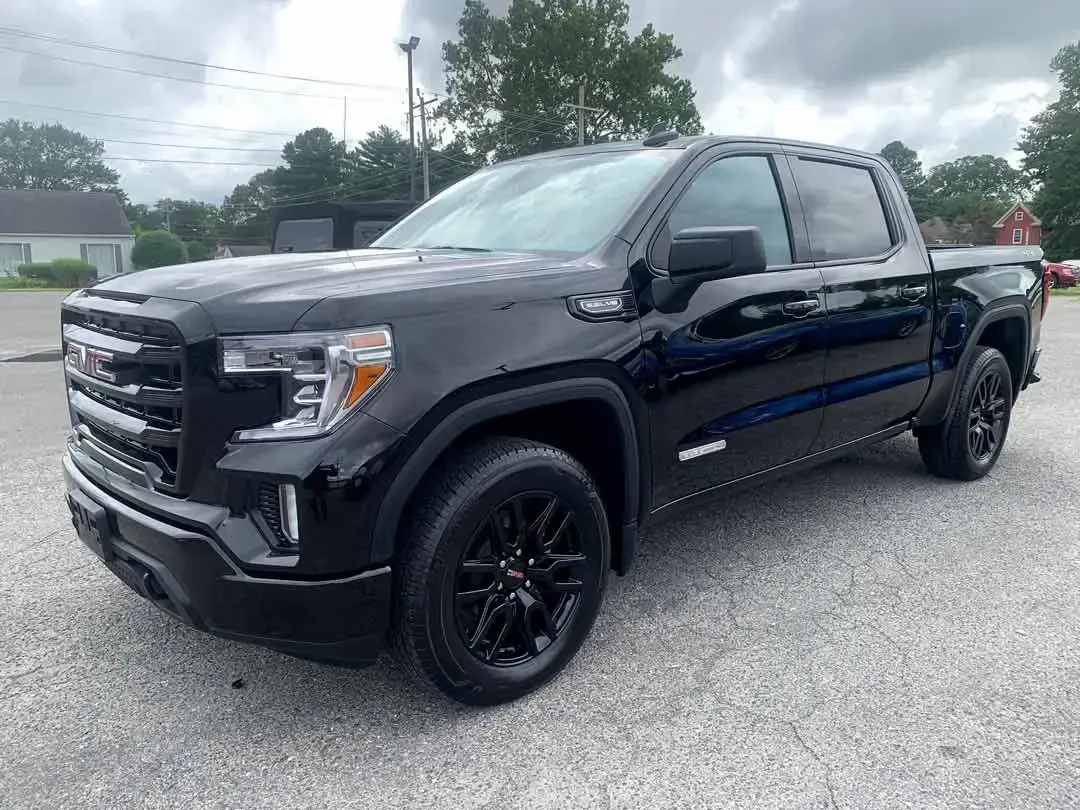 A black pickup truck is parked in a parking lot.