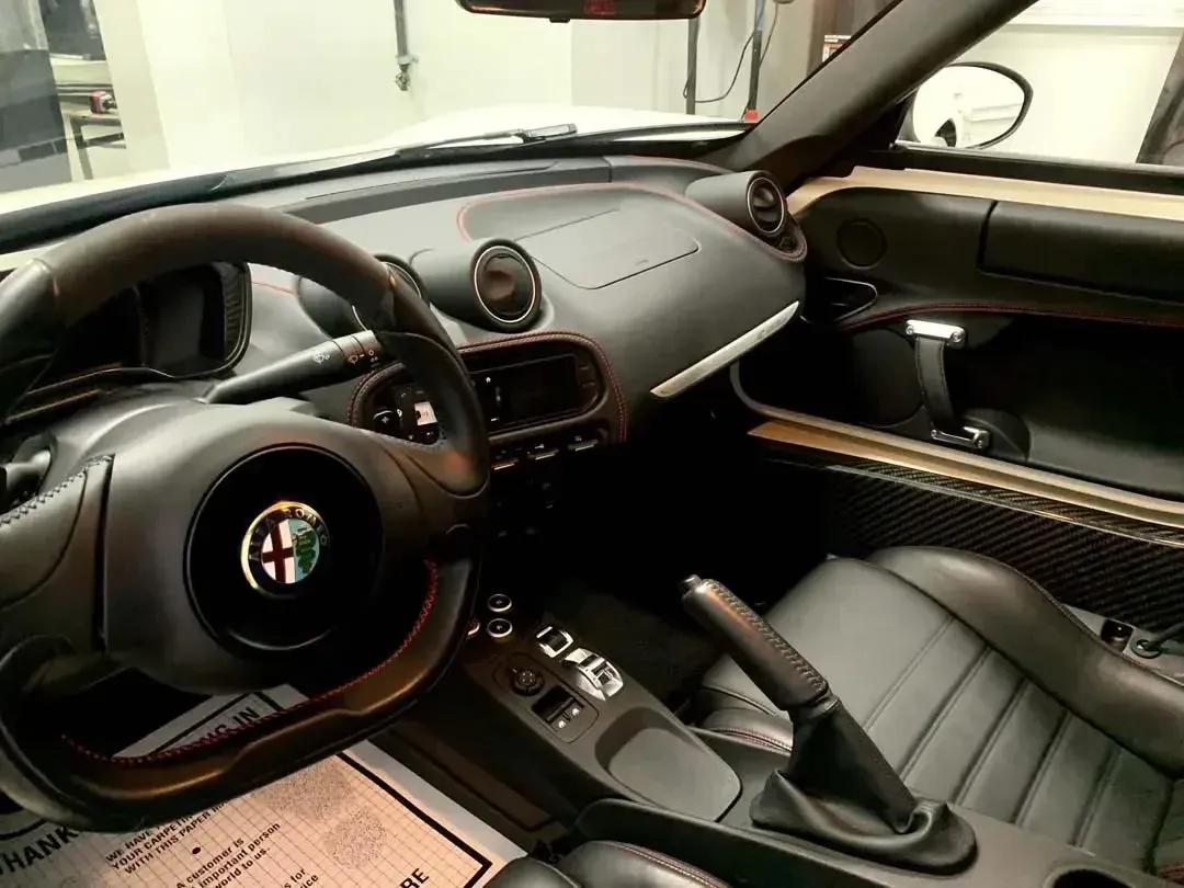The interior of a car with a steering wheel and seats