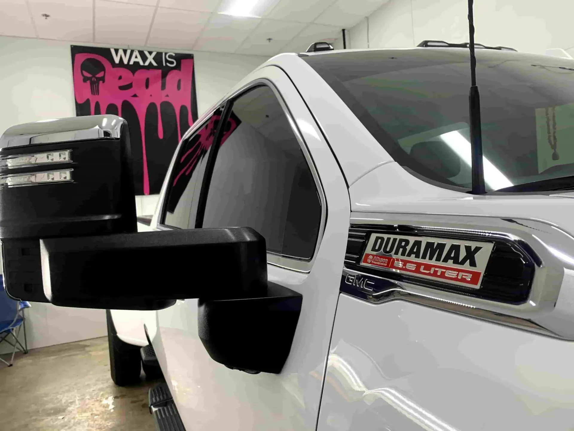 A white truck with the word duramax on the side