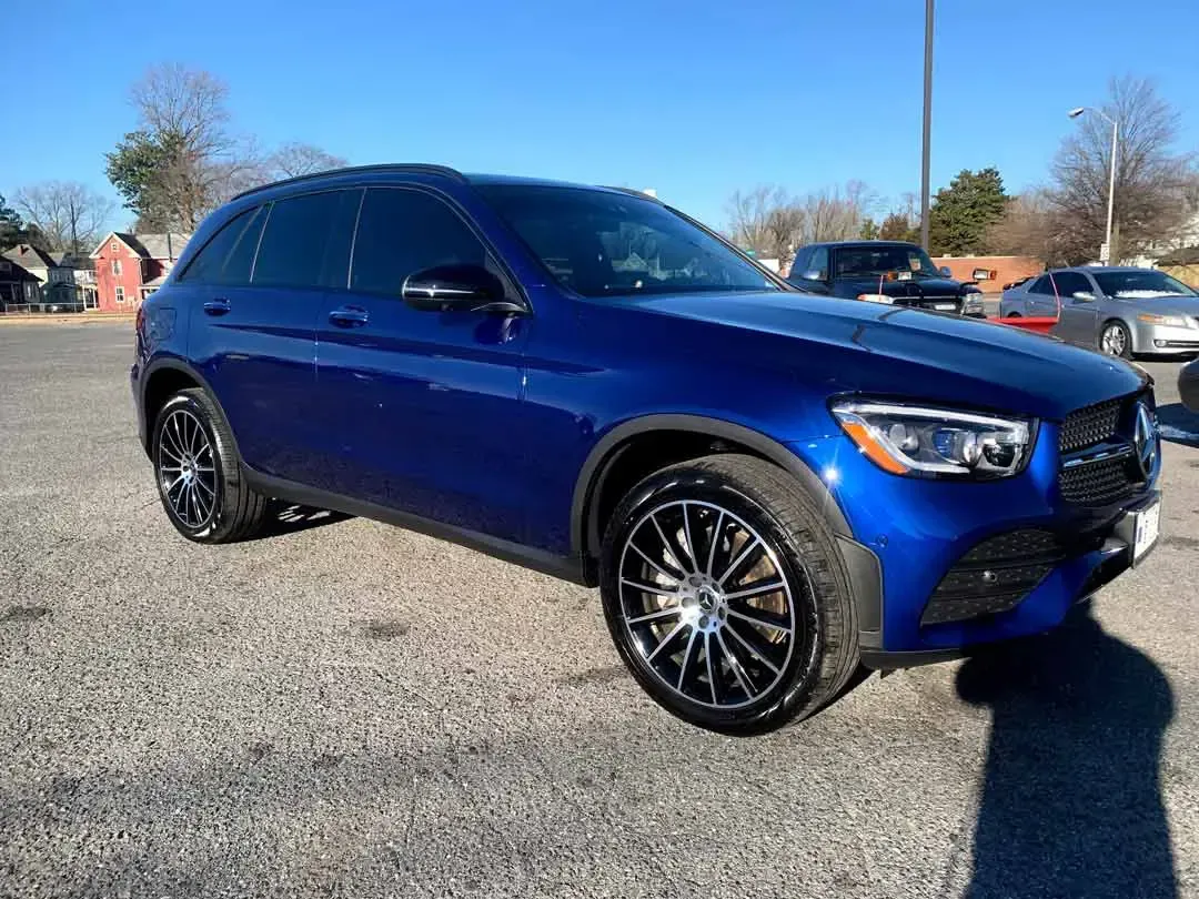 A blue mercedes benz glc coupe is parked in a parking lot.