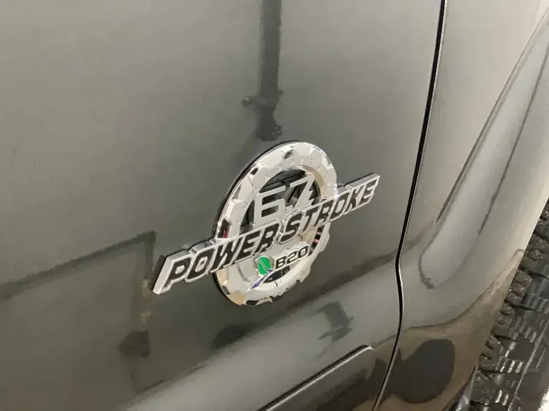 A close up of a power stroke emblem on the side of a truck.
